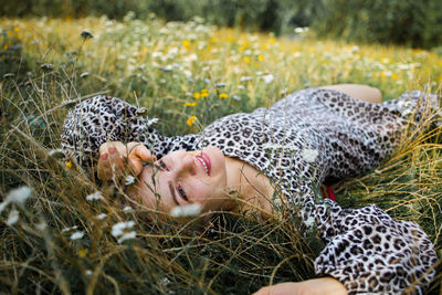 Summer lifestyle portrait middle aged woman lying on the grass 