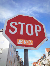 Low angle view of road sign against sky