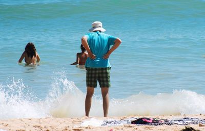 People enjoying at beach on sunny day