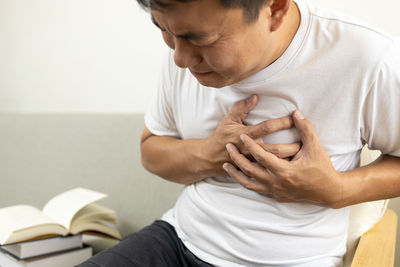 Midsection of couple holding hands