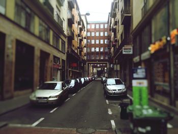 Traffic on city street amidst buildings