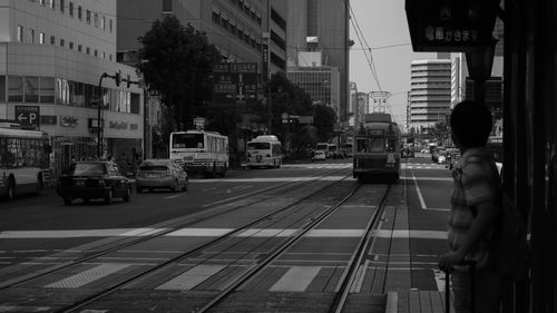 Cable car and vehicles on street in city