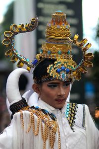 Close-up of young man wearing headdress during traditional festival