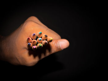 Close-up of hand holding multi colored candies