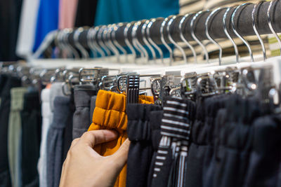 Cropped hand of woman holding shopping bags