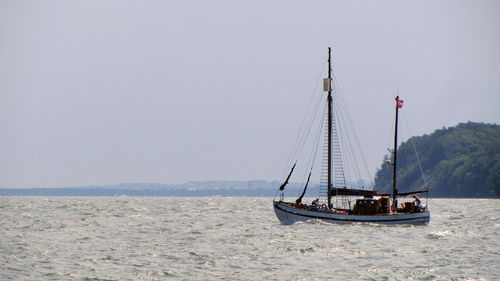 Boats moving on sea against sky