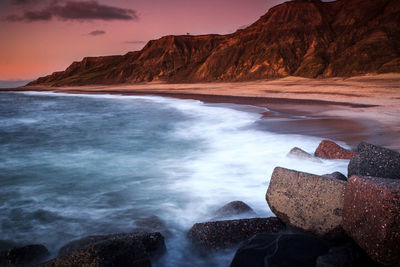 Long exposure image of sea against sky during sunset