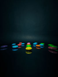 Close-up of illuminated lights against black background