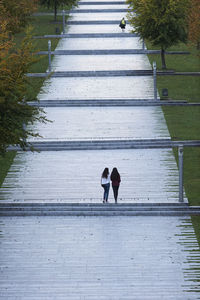 Full length of woman walking on footpath