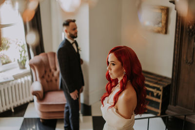 Wedding day. happy bride and groom standing and smiling. red hair diversity