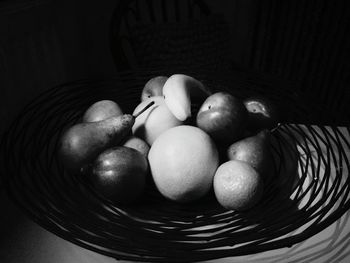 Close-up of fruits in basket against black background