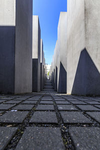 Walkway in city against sky