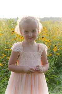 Portrait of smiling girl standing against plants