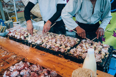 Midsection of vendor working at stall