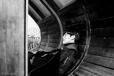 Young man napping on bench