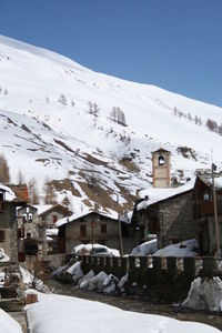 Houses in town against clear sky during winter