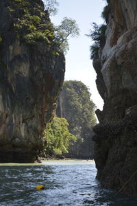 Rock formation by sea against sky