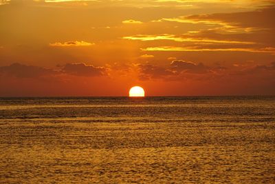 Scenic view of sea against orange sky