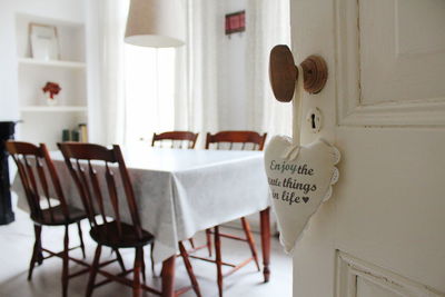 Close-up of text on heart shaped decoration hanging on door