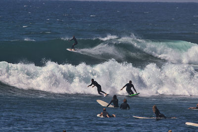 People surfing in sea