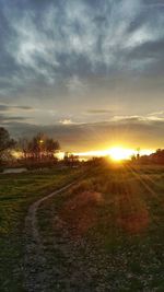 Scenic view of field against sky during sunset