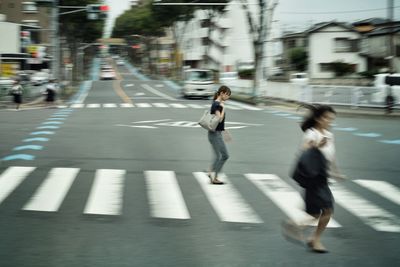 People running on road in city