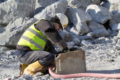 Man working on rock at construction site