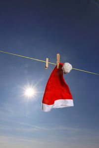 Low angle view of red flags against sky