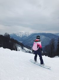 Full length of man on snowy mountain against sky