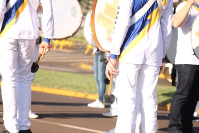 Low section of people walking on road