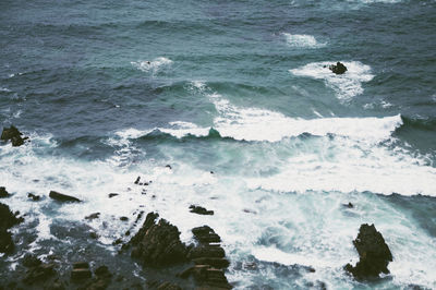 High angle view of waves on shore