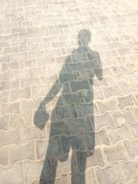 Shadow of person on footpath