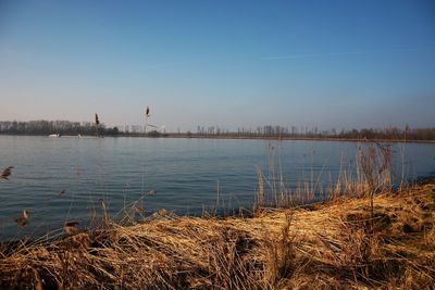 View of lake against blue sky