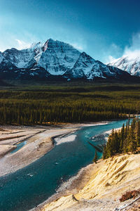 Aerial view of river by landscape against blue sky