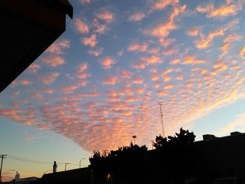 Silhouette of building against cloudy sky