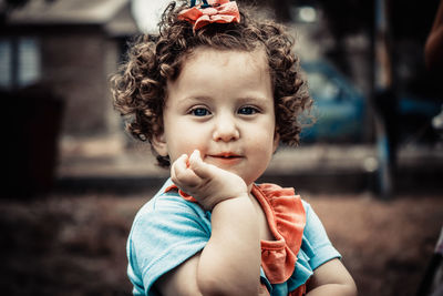 Portrait of cute girl holding camera