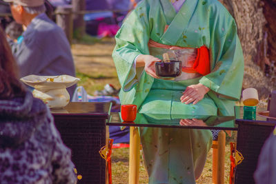 Rear view of woman holding map