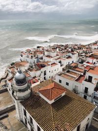 High angle view of townscape by sea