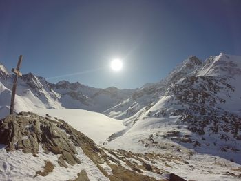 Scenic view of snowcapped mountains against clear sky