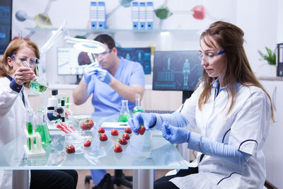 Female doctor examining chemical in laboratory