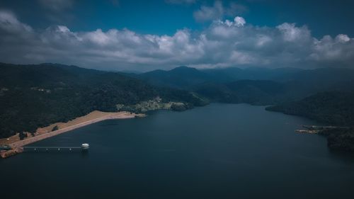 Scenic view of lake and mountains against sky