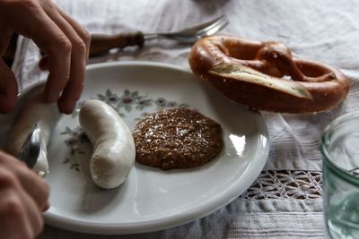 High angle view of hand holding bread in plate