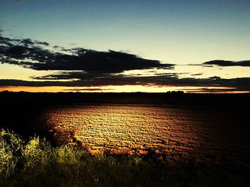 Scenic view of field against sky during sunset