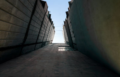 Low angle view of empty alley amidst buildings