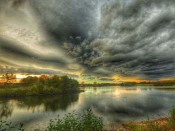 Scenic view of lake against dramatic sky