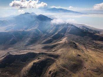 Aerial view of mountain range against sky