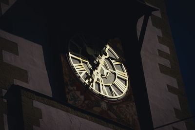 Low angle view of clock tower against building