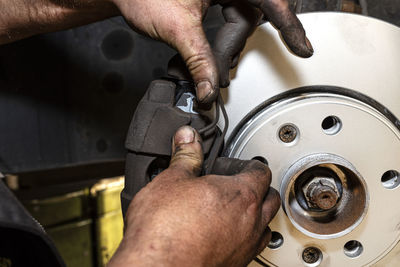 New brake disc with an anti-corrosion layer, mounted on the front hub, installing the brake pads.