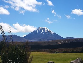 Scenic view of mountains against blue sky