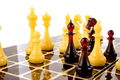Close-up of chess pieces against white background